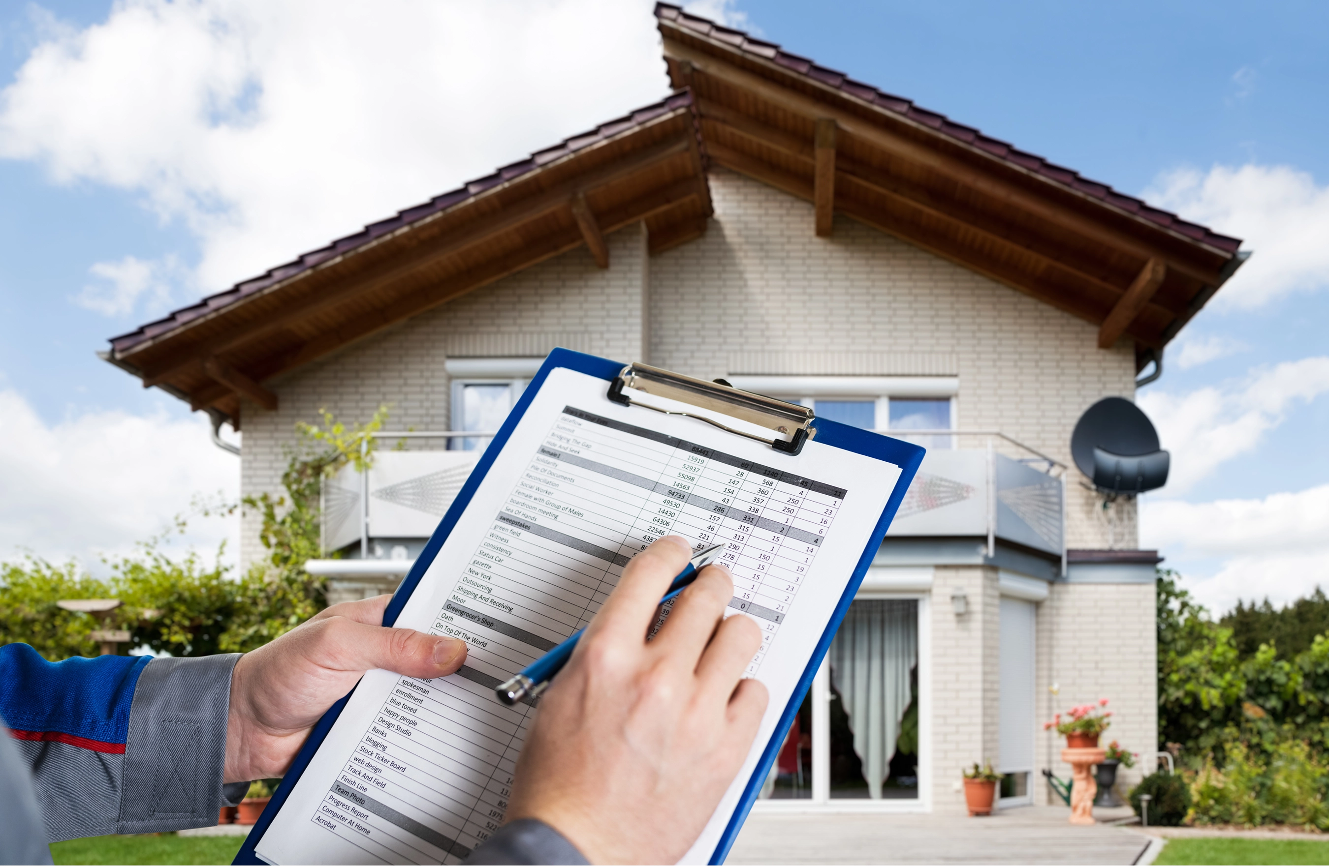 Person with clipboard inspecting a house.
